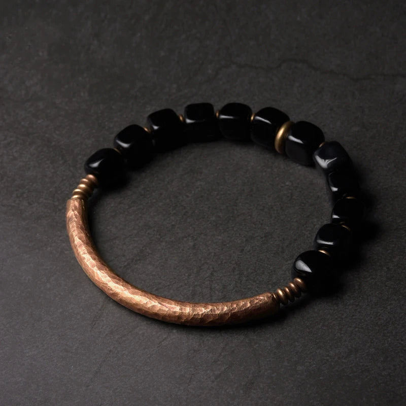 Bracelet da obsidian ner da fatg a man.